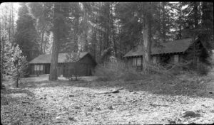 Two simple, rustic, one-story buildings that serve as the Cabin Creek Ranger Station and Dormitory nestle amid the tall straight trunks of the mixed conifer forest in Sequoia National Park. Made of wood, and painted the traditional brown and green to blend with the trees, they have stone chimneys and native granite facing on their foundations to further harmonize them with their beautiful natural surroundings.